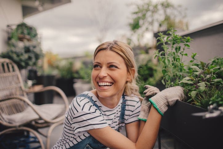smiing woman working on her garden