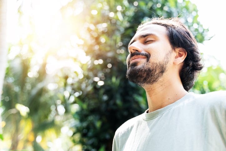 Man daydreaming outdoors.