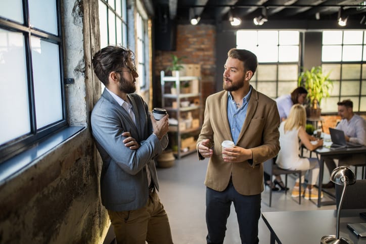Businessman talking to each other in office