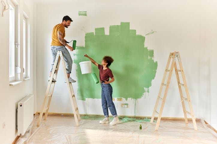 couple painting in room
