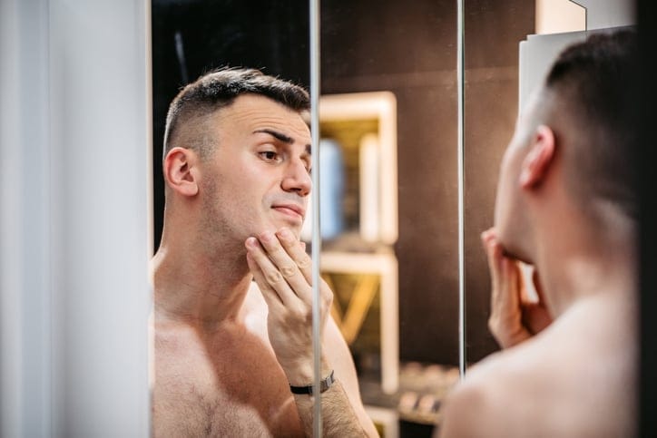 Man looking in the mirror.