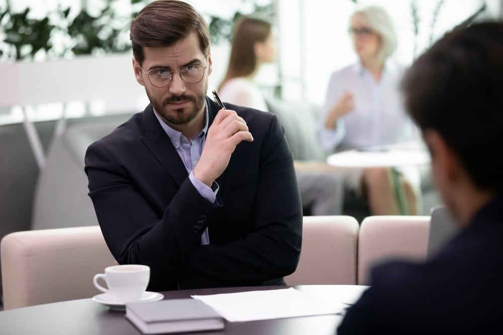 Businessman in a meeting looking serious.