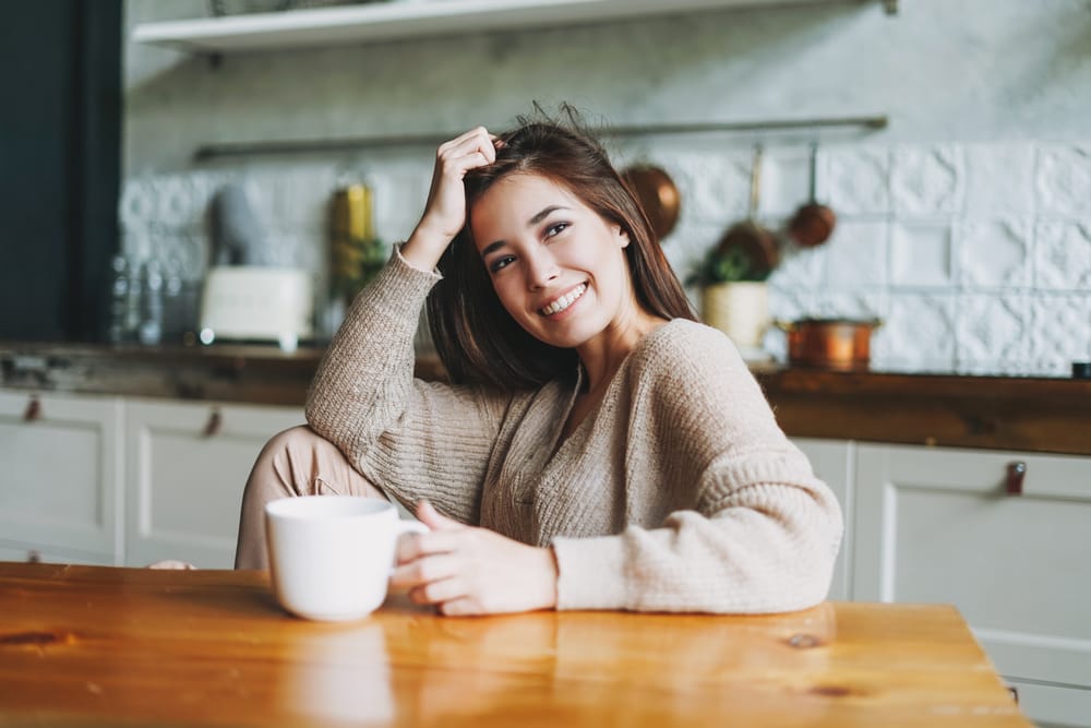 Woman cozy and happy to be staying in.
