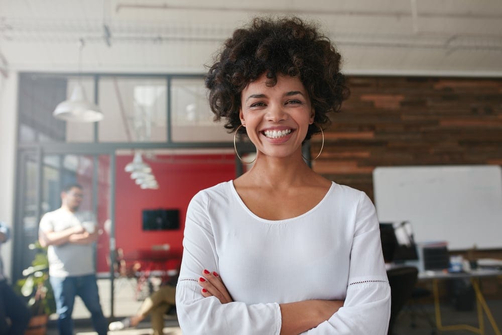 Woman smiling at a cafe.