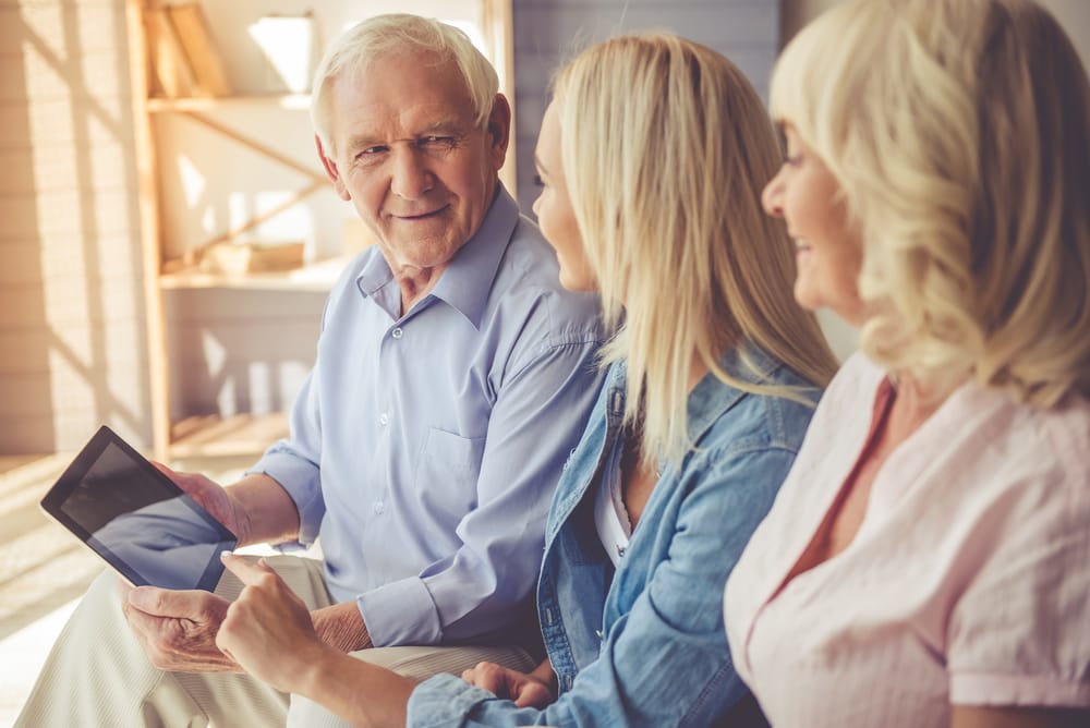 Woman talking to older friends.