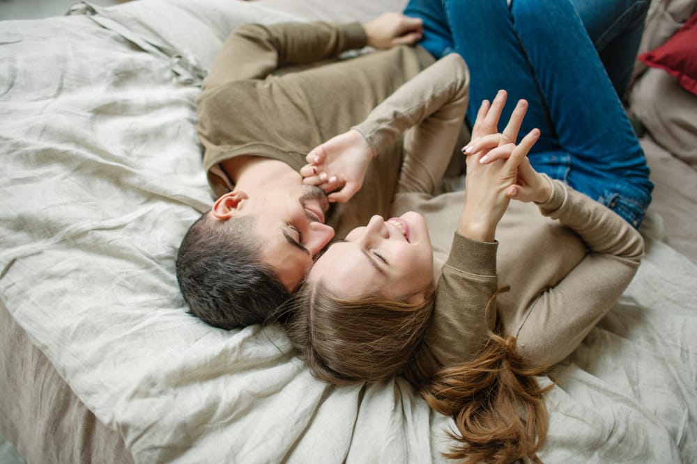 Couple lying in bed.