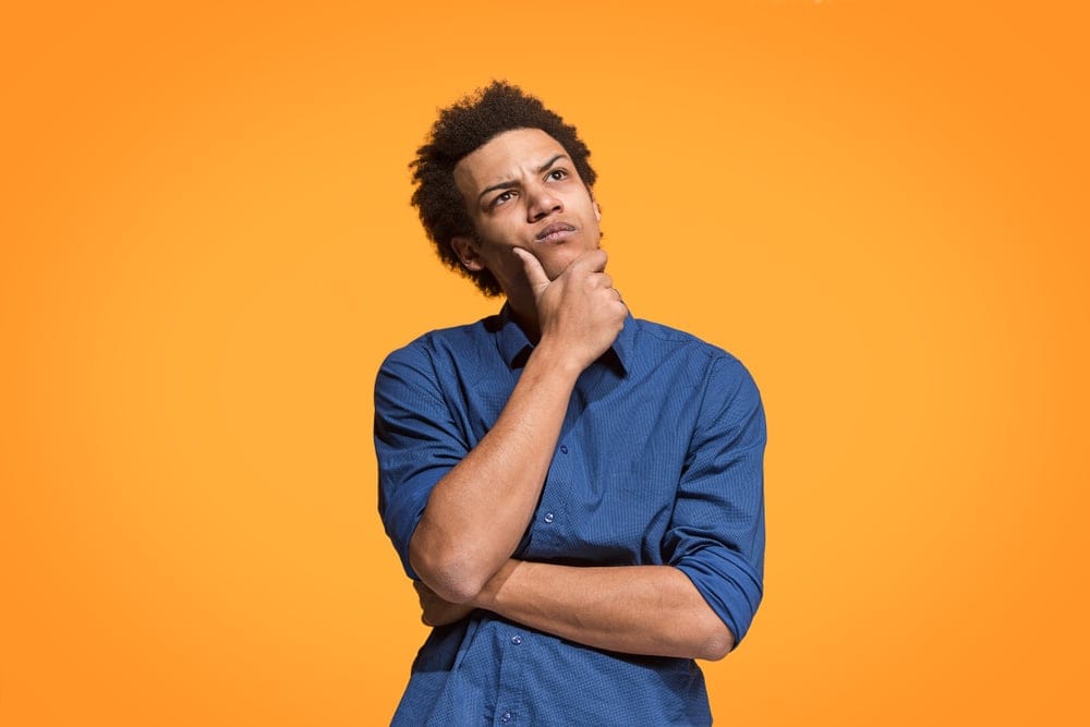 Man thinking with his hand on his chin.
