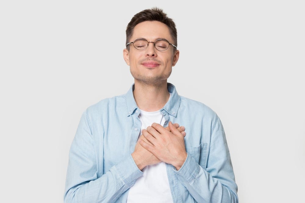 Man holding his hands to his heart.