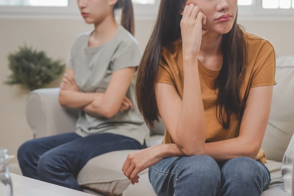 Two unhappy friends sitting together.