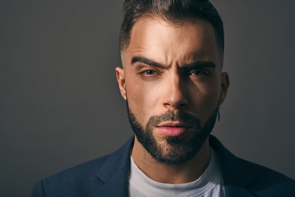 Man looking angry with a serious face.