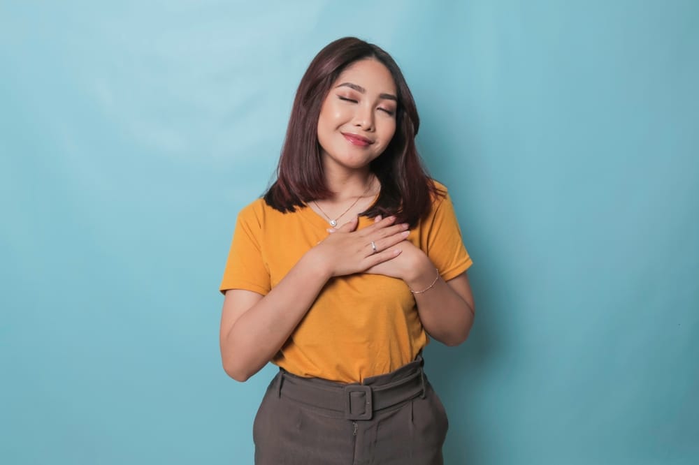 Young woman looking thankful.