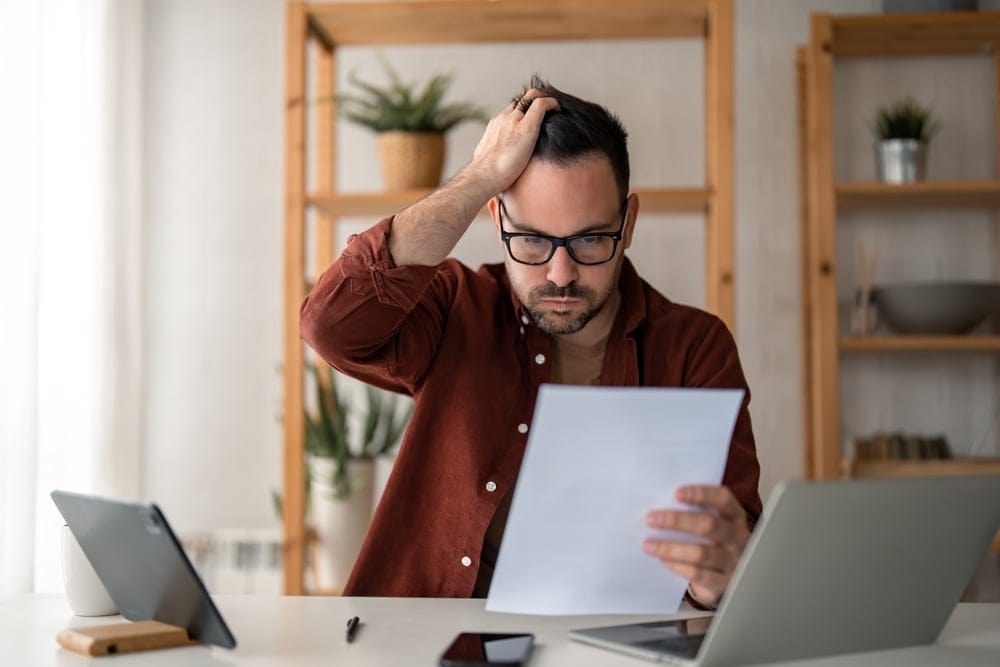 stressed man working out finances