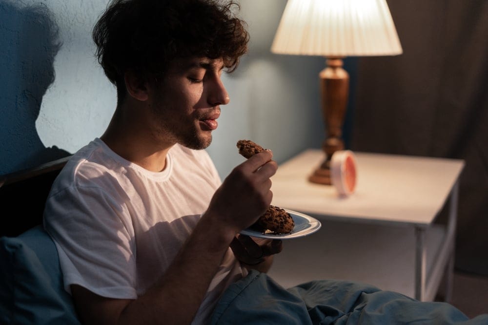 Man eating a baked good.
