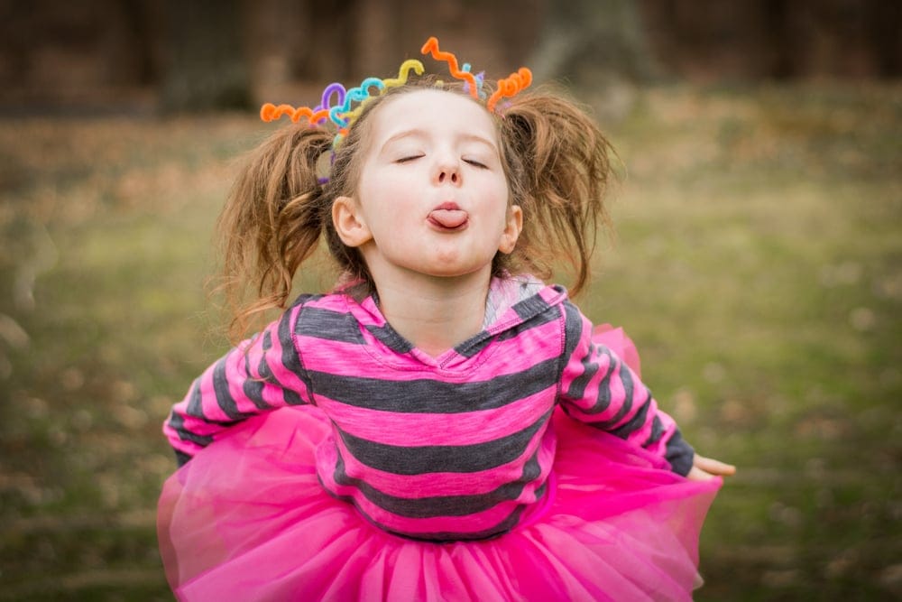 Young girl sticking her tongue out.