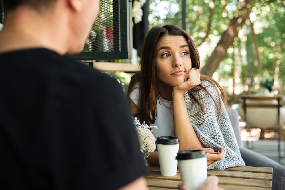 Tired woman talking to her friend.