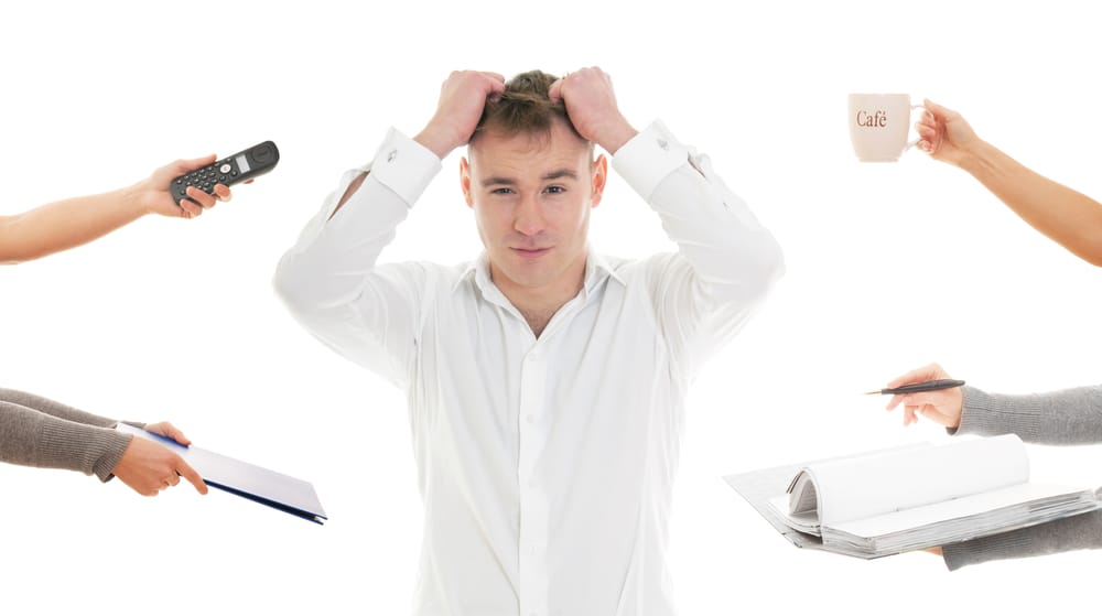 Overcommitted man feeling stressed.