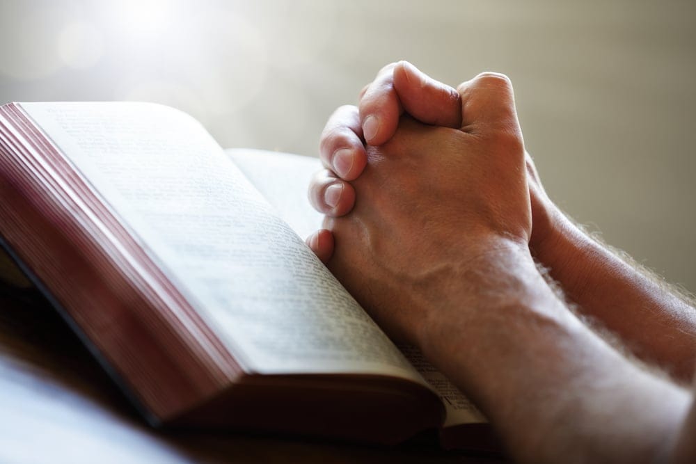 Hands folded in prayer.