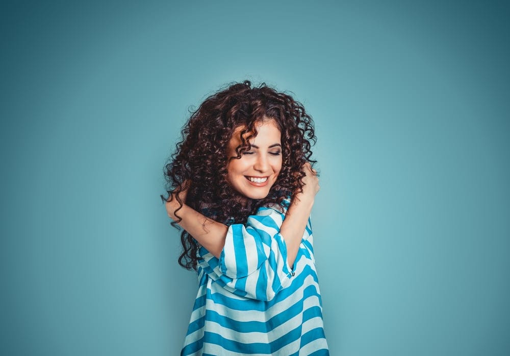Woman giving herself a hug.