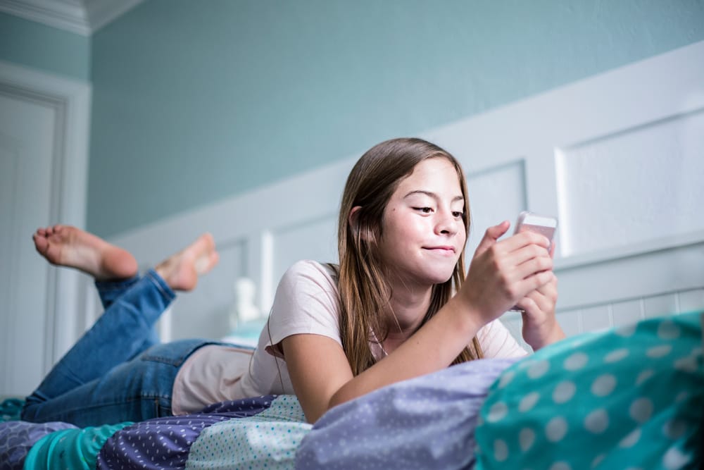 Teenage girl in her room on the phone.