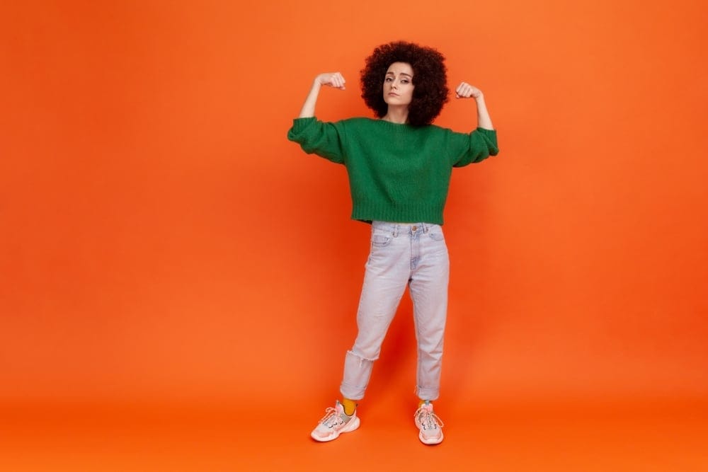 Woman showing a sign of strength with her gesture.