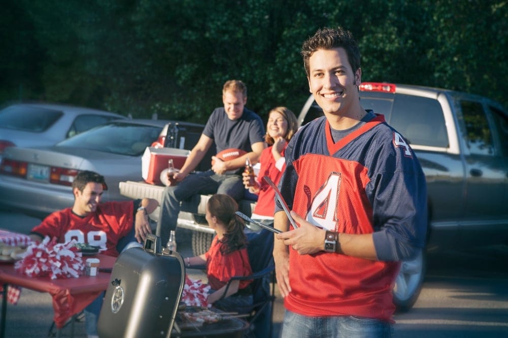 Group,Of,Friends,At,A,Football,Tailgating,Party,Outside.