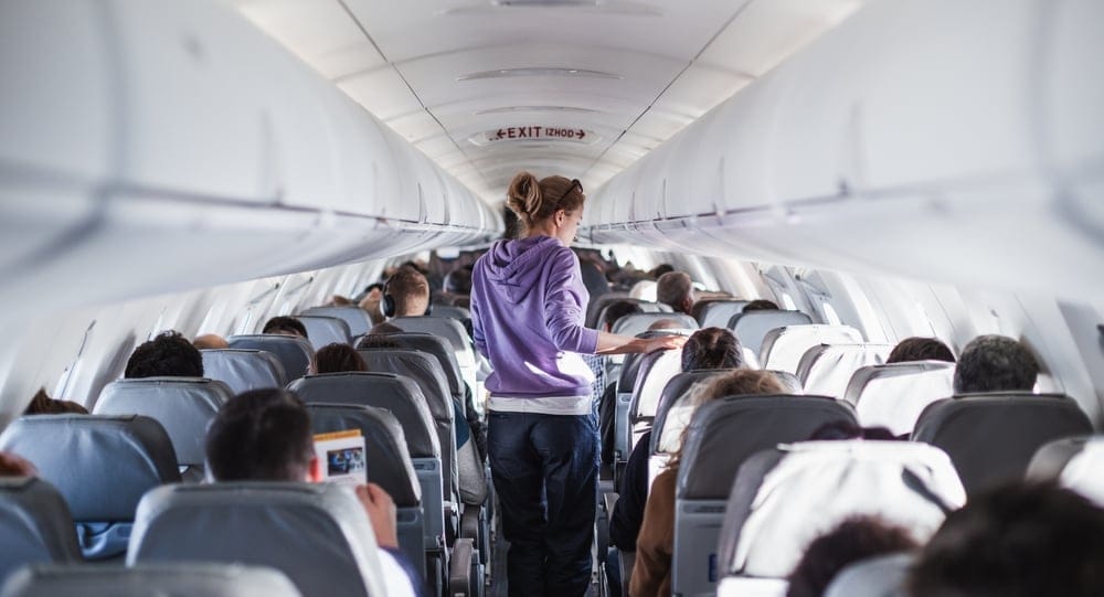 Airline passengers watching movies.