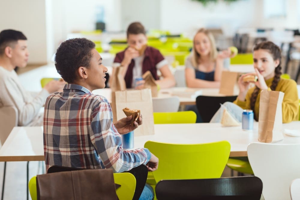 High school students eating lunch in the cafeteria.