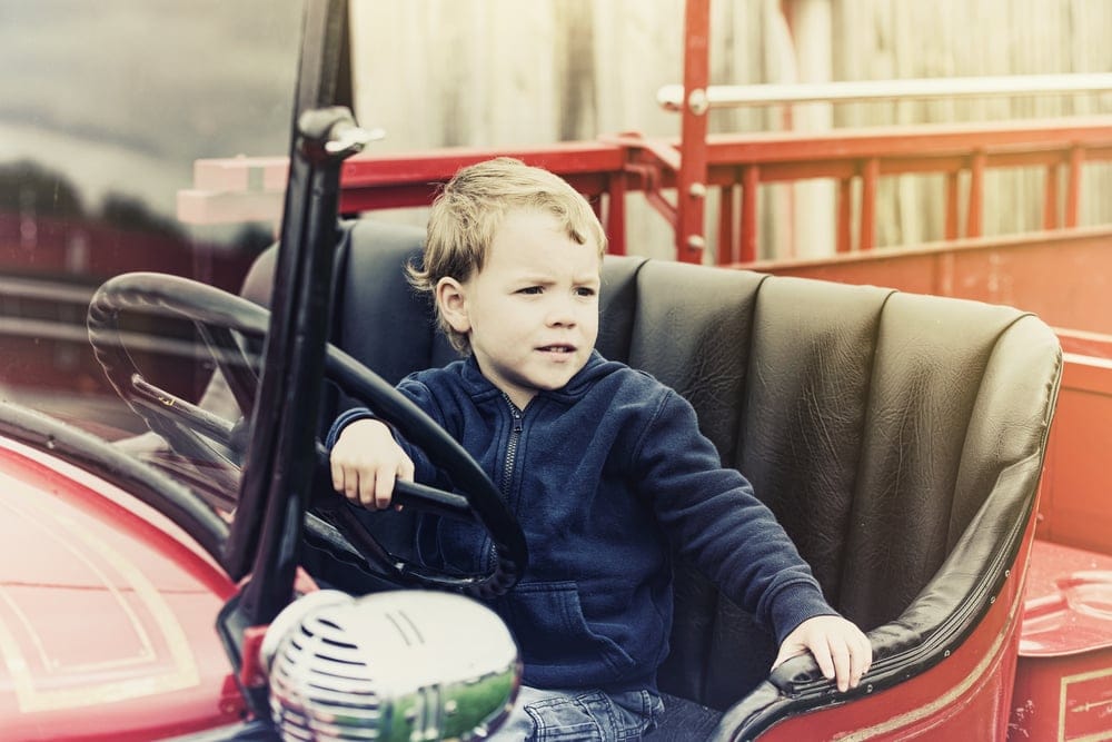 A,Happy,Young,Boy,Sits,In,An,Old,Shiny,Vintage