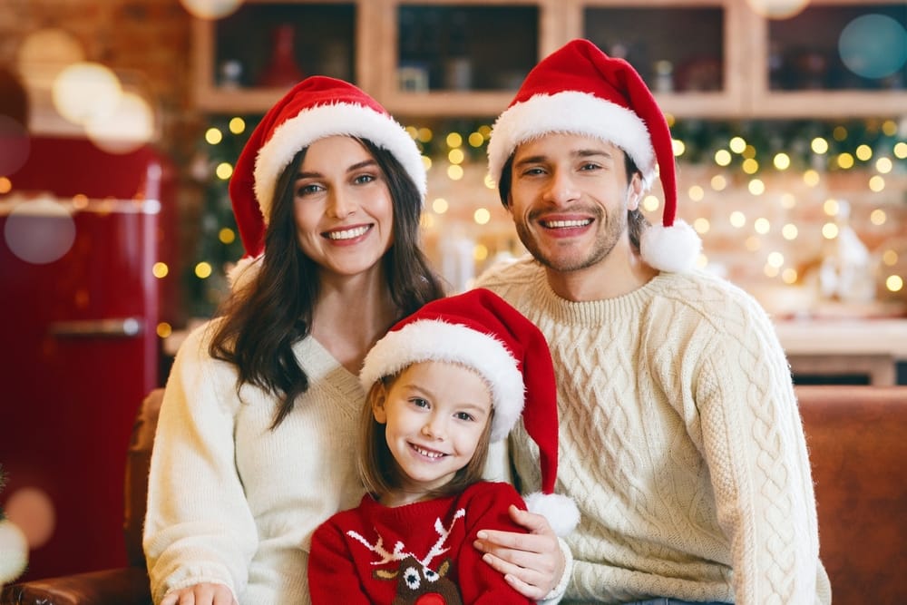 Family in Santa hats celebrating Christmas.