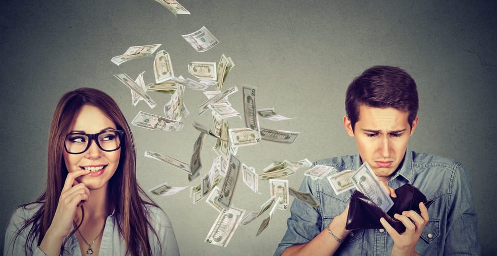 Money flying out of a man's wallet.
