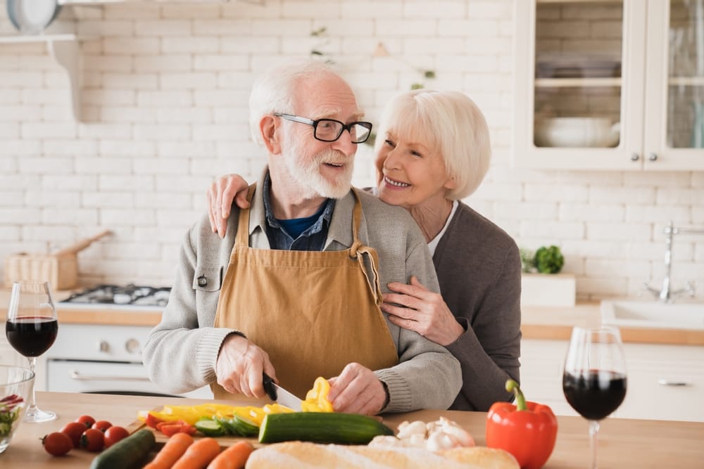 Older couple cooking together.