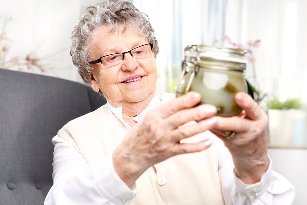 Grandmother holding up her possessions.