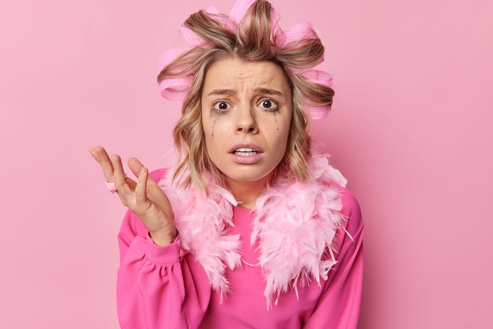 Woman with her hair in curlers.
