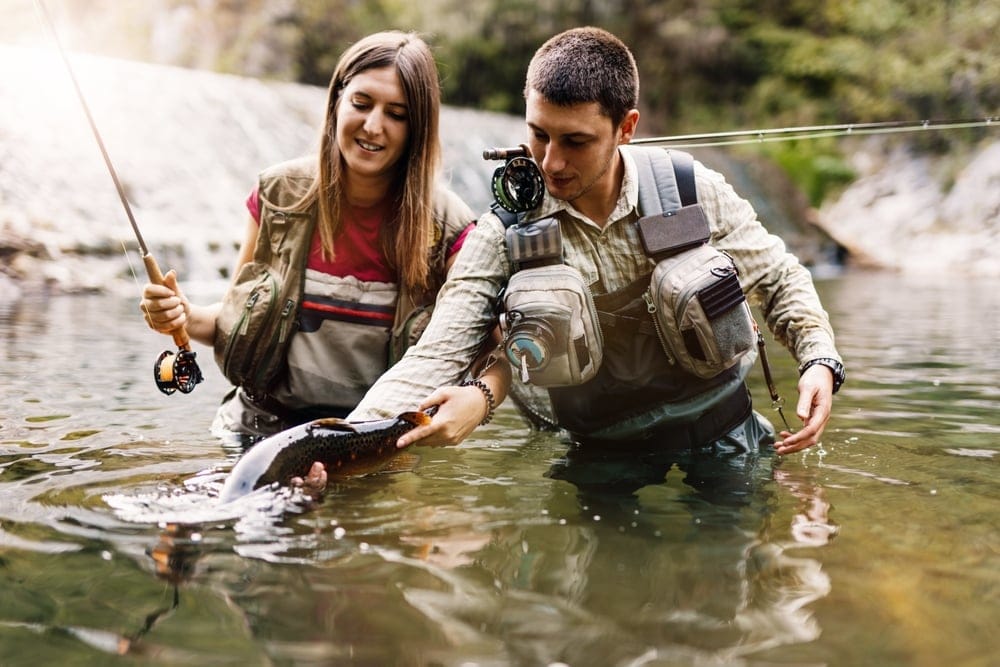 A young couple flyfishing.