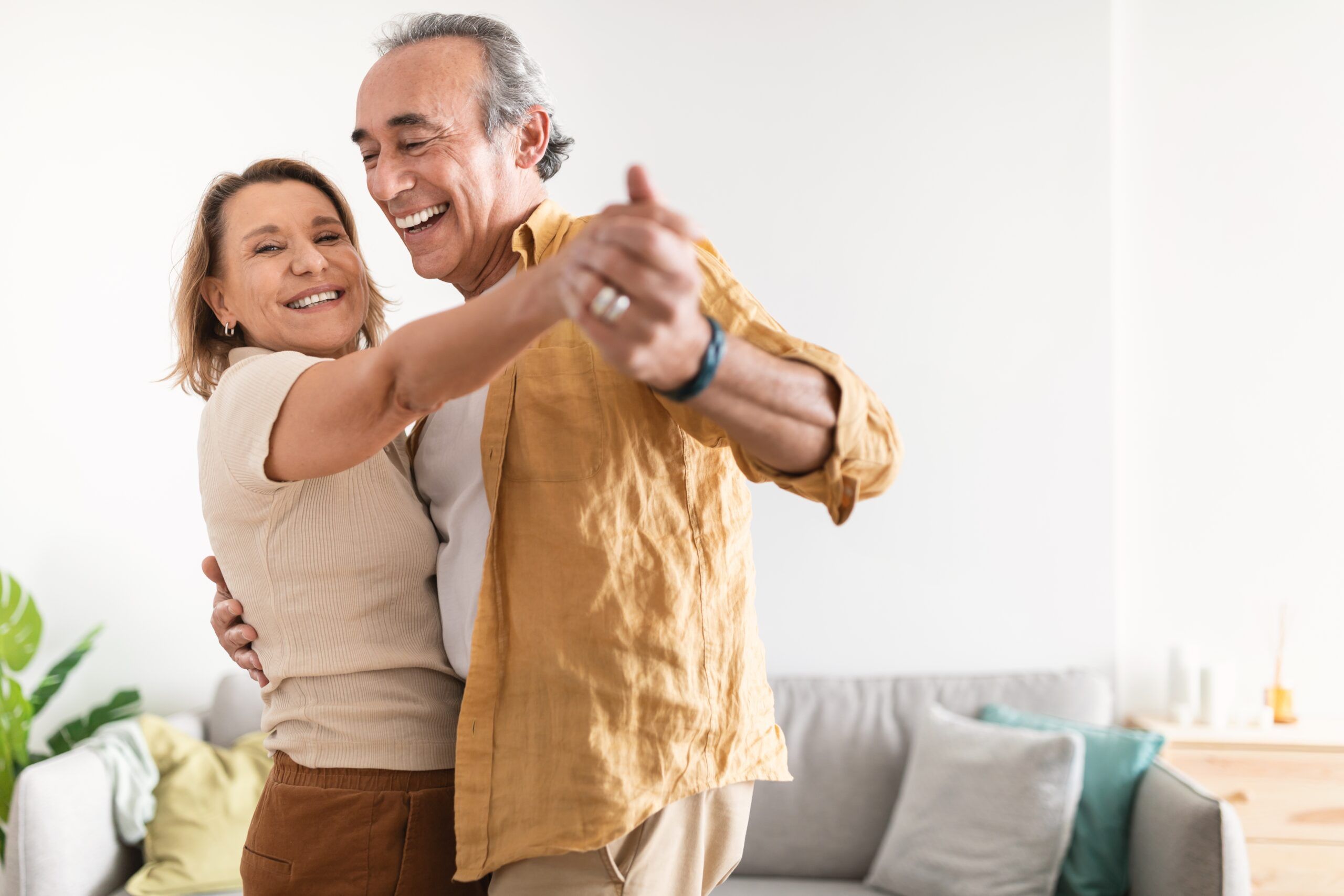 Happy older couple dancing together.