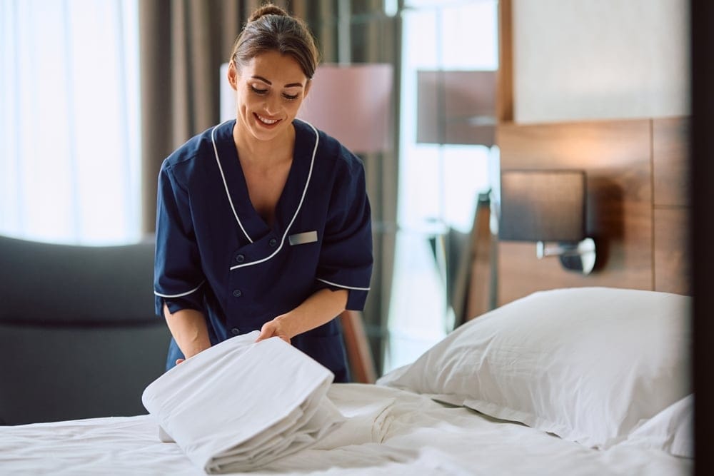 Maid cleaning a hotel room.