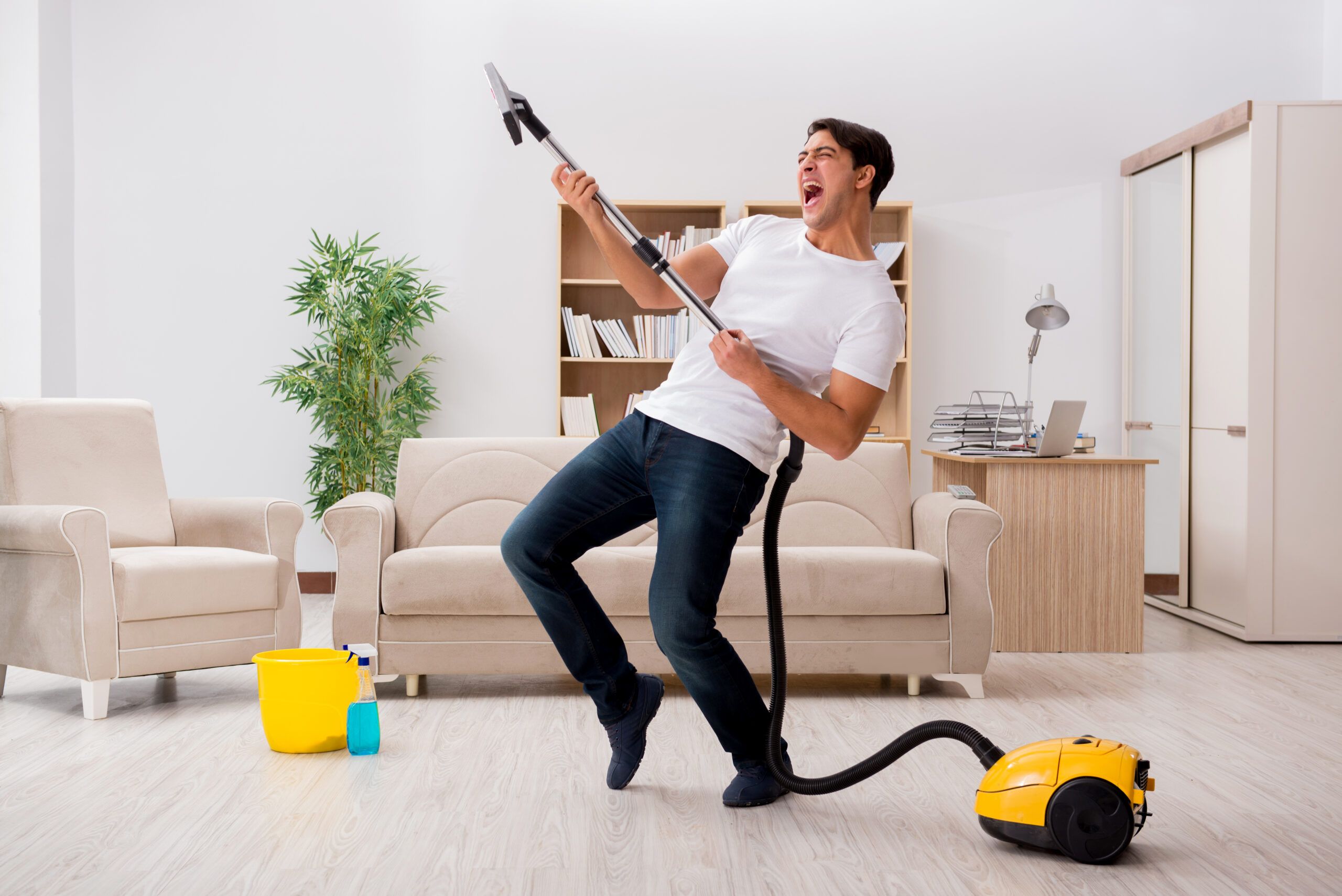 Man,Cleaning,Home,With,Vacuum,Cleaner