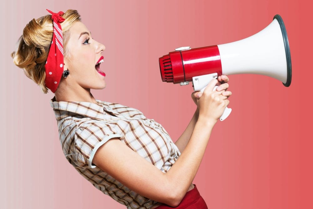 Woman yelling in a microphone.