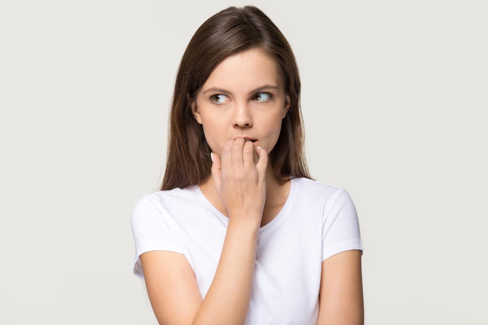 Young woman looking insecure.