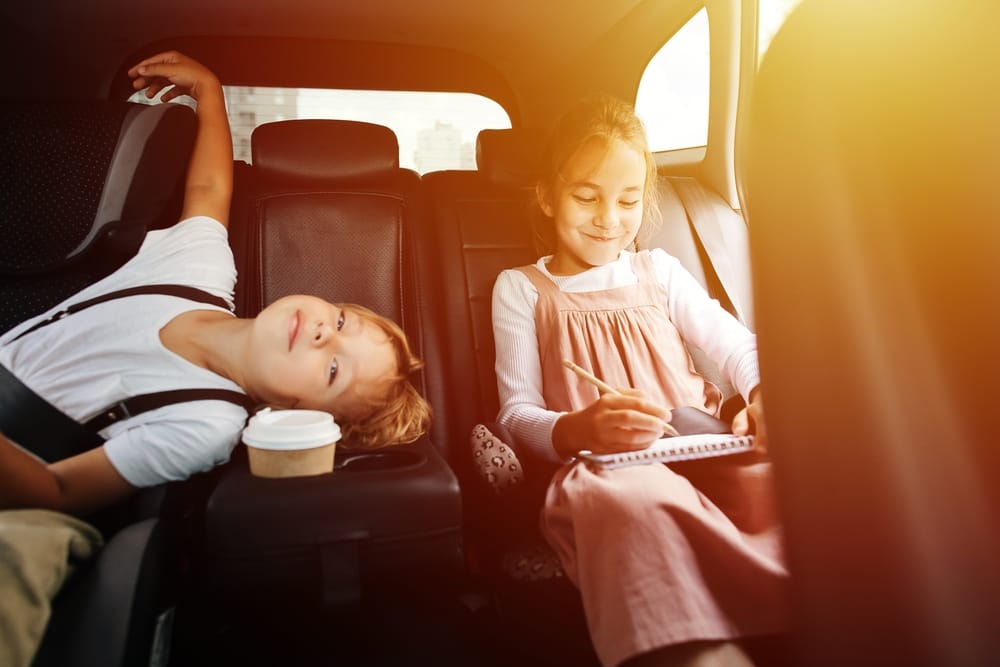 Children in the backseat of a car.