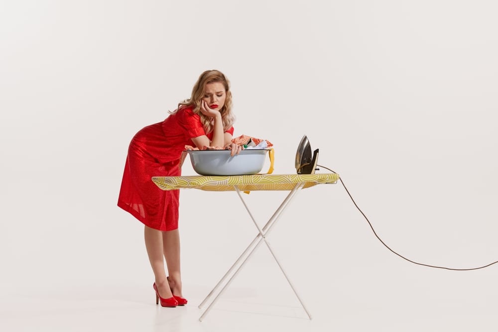 Woman in fancy dress ironing.