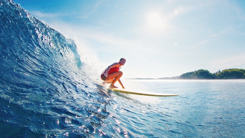 Woman surfing in the ocean.