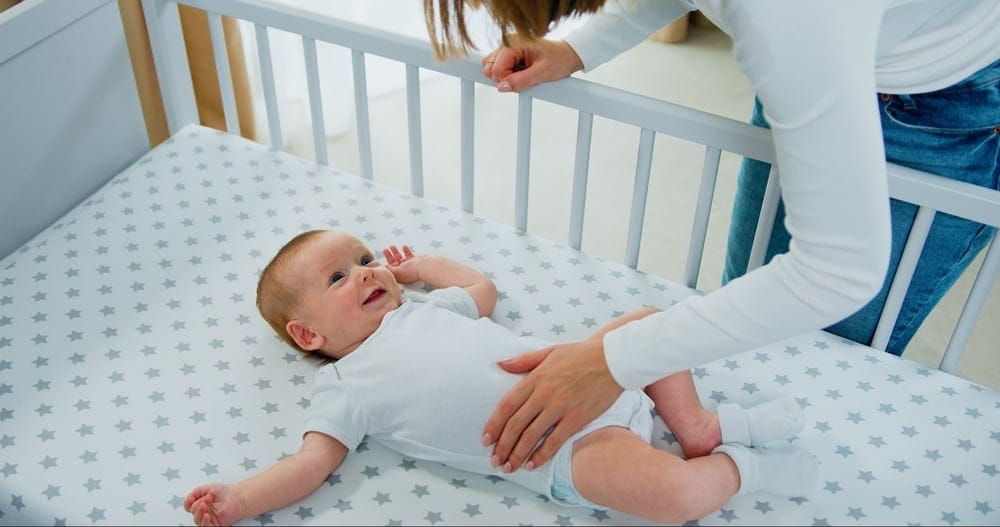 Woman with a baby in a crib.