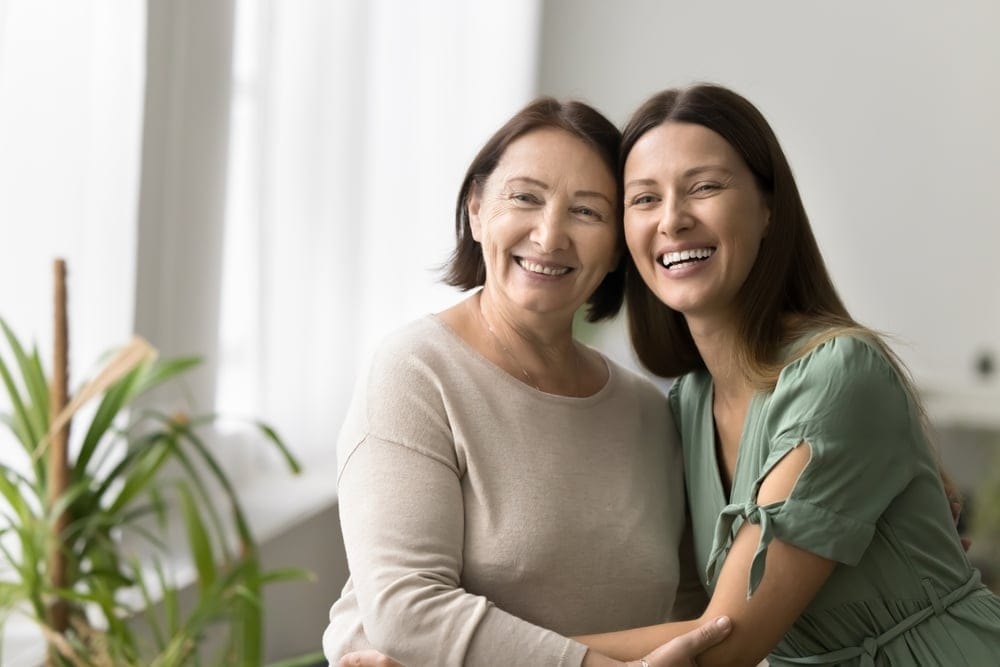 Mother and daughter embracing.