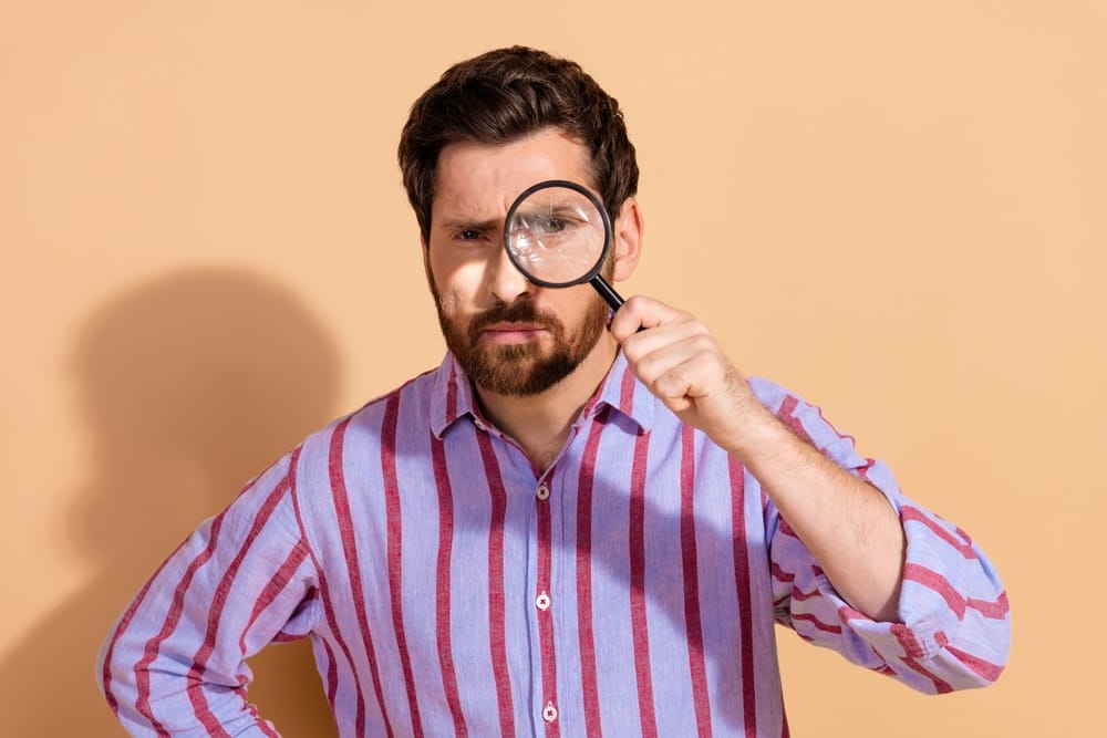 Man with a magnifying glass.
