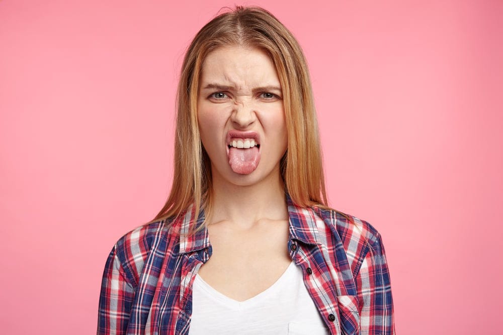 Woman frowning with her tongue out.