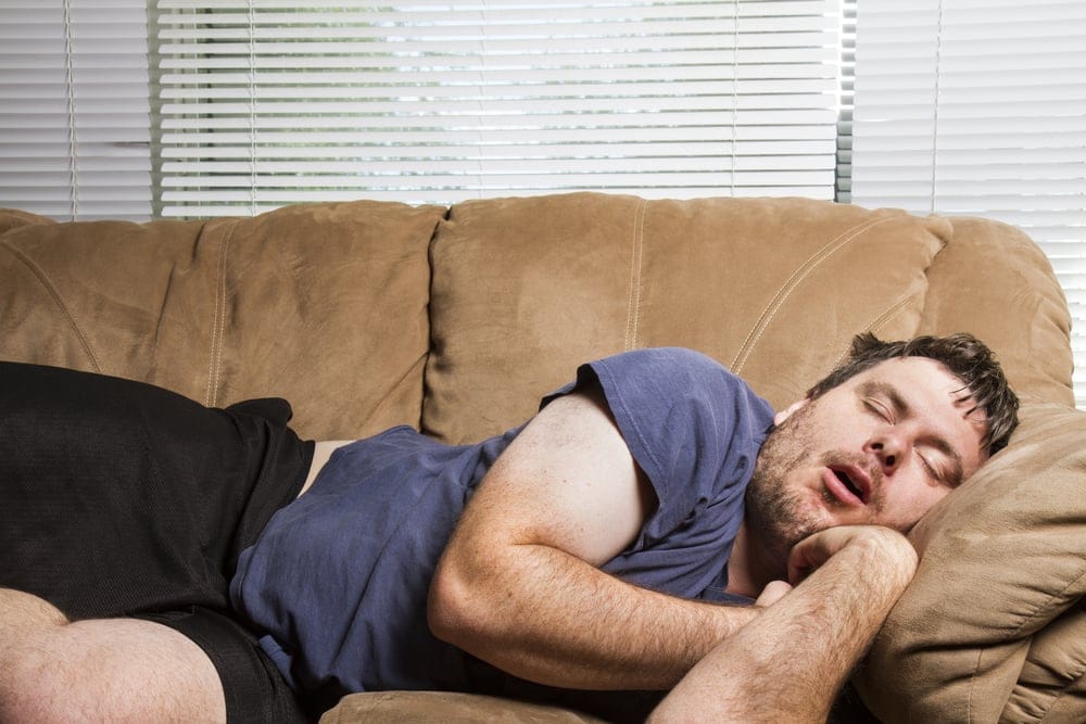 Man laying on the couch for a nap.
