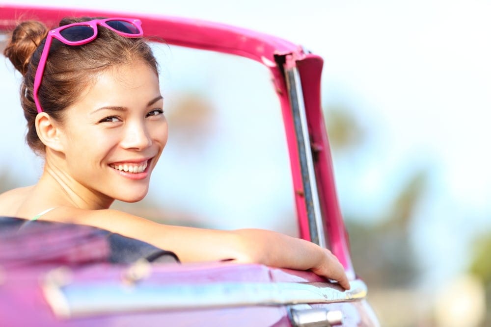 Woman smiling in her car.