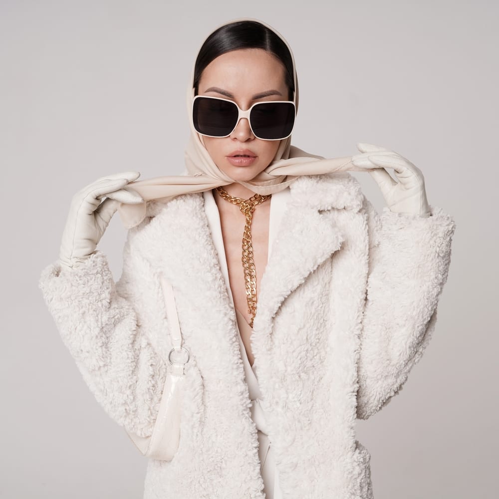 Woman wearing sunglasses inside.