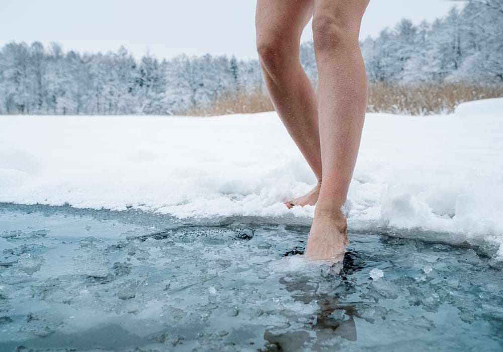 Female legs walking in water.